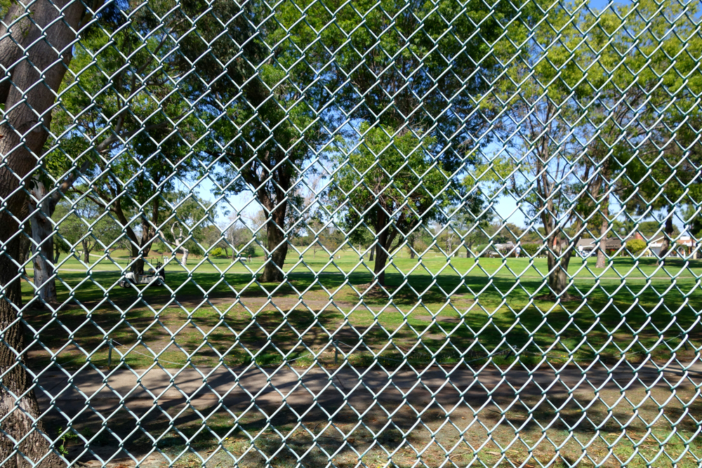 another golf course with chainwire fence